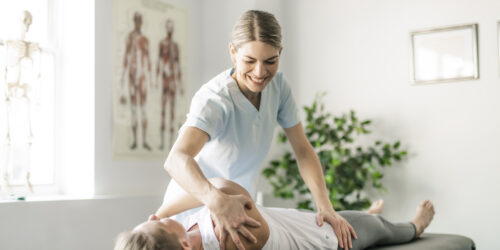 A Modern Rehabilitation Physiotherapy Worker With Woman Client