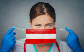 Coronavirus,In,Austria,Female,Doctor,Portrait,Hold,Protect,Face,Surgical