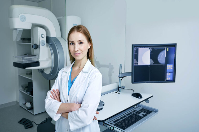 Experienced,Female,Radiologist,Standing,Near,Mammography,Workstation,At,Radiology,Room