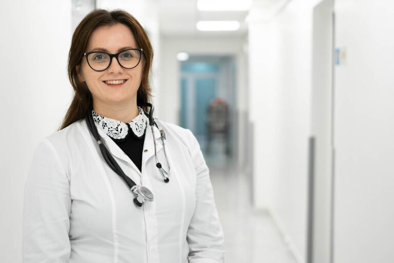 Confident,Smiling,Young,Woman,Doctor,Standing,In,Medical,Institution.,Proud