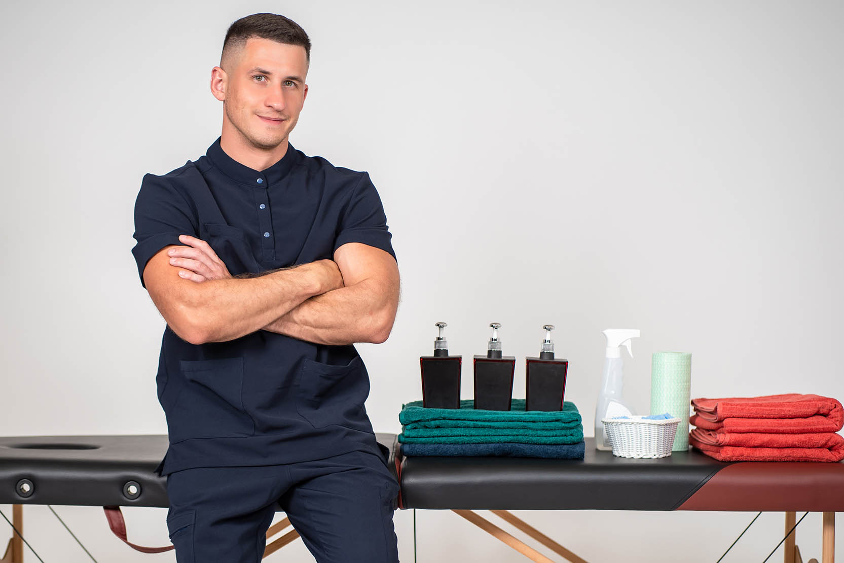 Massage,Parlor,Employee.,Masseur,Stands,With,His,Arms,Crossed.,Masseur