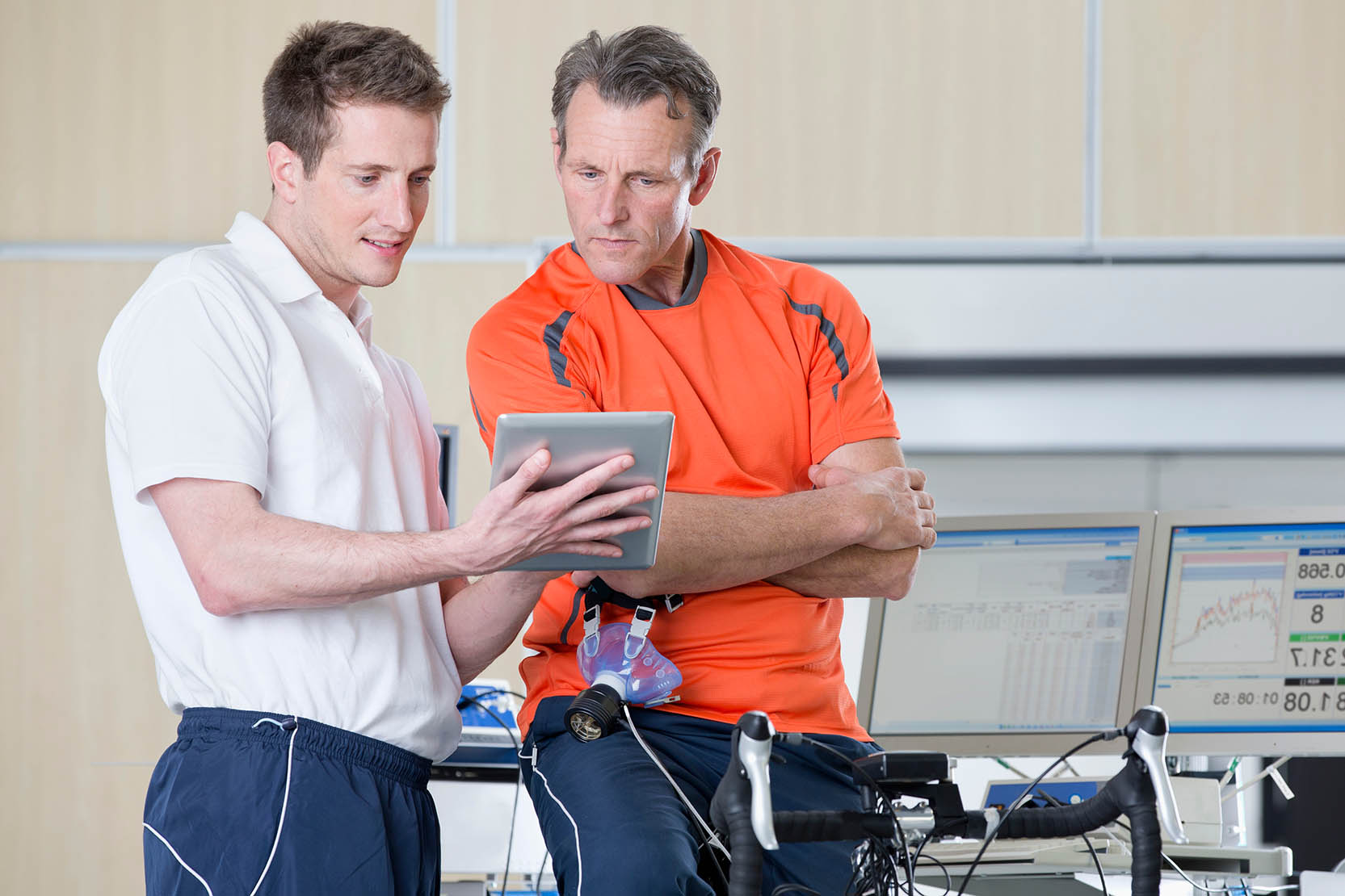 Wide,Shot,Of,A,Sports,Scientist,Explaining,A,Senior,Man
