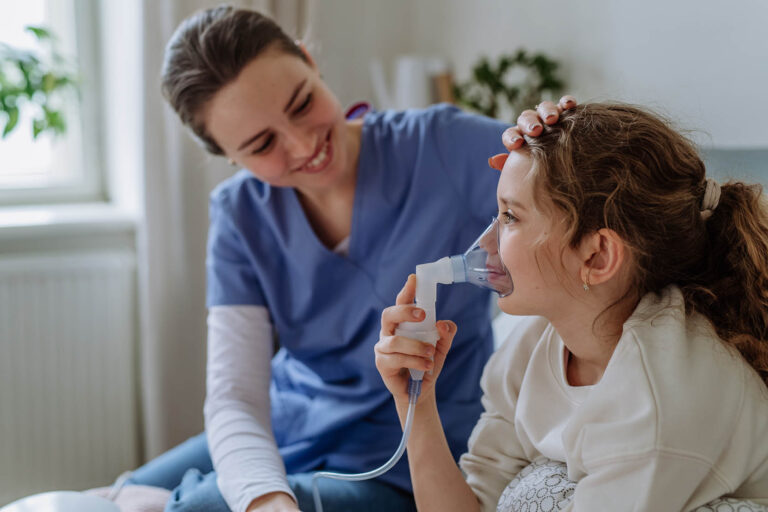 Little,Girl,With,Inhaler,In,Hospital,Room,,Nurse,Chcecking,Her.