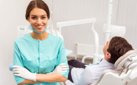 Portrait,Of,A,Young,Dentist,With,Folded,Hands,,Against,The