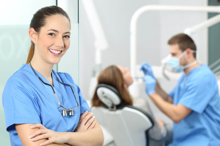 Dentist,Female,With,Crossed,Arms,Wearing,Blue,Coat,Posing,And