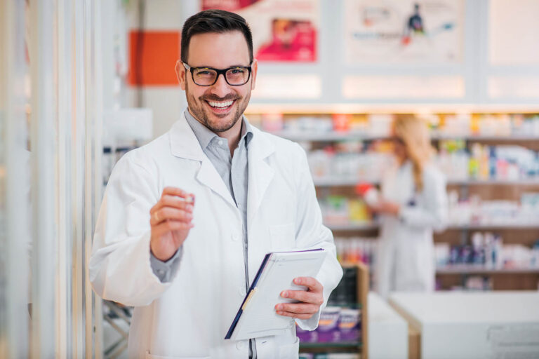 Portrait,Of,A,Handsome,Pharmacist,With,Clipboard,,Smiling,At,Camera.