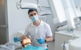 Male,Dentist,Working,With,A,Patient,And,Making,Teeth,Restoration