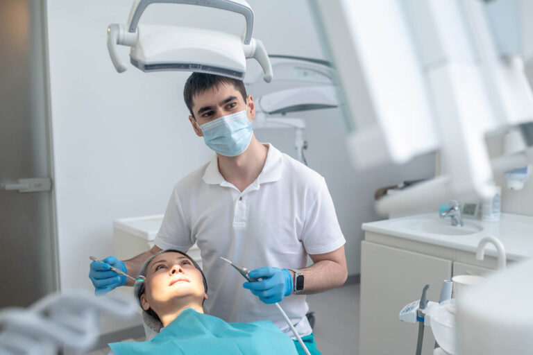 Male,Dentist,Working,With,A,Patient,And,Making,Teeth,Restoration
