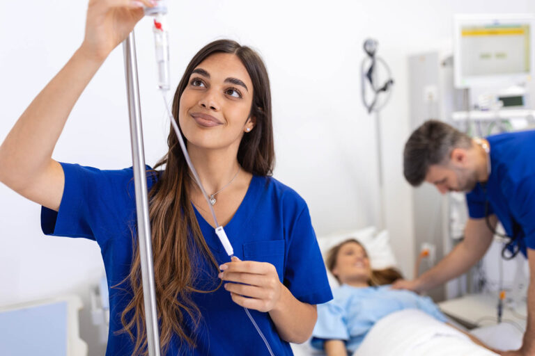 Young,Woman,Doctor,Anesthesiologist,Dressed,In,Blue,Gown,,Puts,The