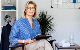 Professional,Psychotherapy.,Successful,Female,Psychologist,Smiling,To,Camera,Sitting,On