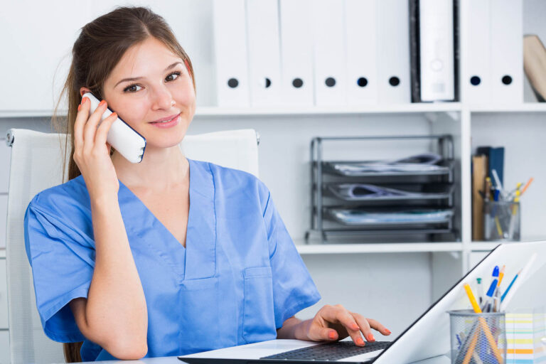 Portrait,Of,Young,Female,Doctor,Talking,On,Phone,In,Medical