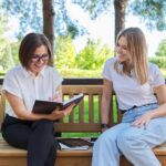 Woman,Teacher,And,Girl,Student,Teenager,Sitting,On,The,Bench