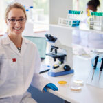 Portrait,Of,A,Young,Female,Lab,Technician,Smiling,While,Sitting