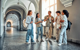 College,Students,Stand,And,Talk,In,The,University,Building.,Multiethnic